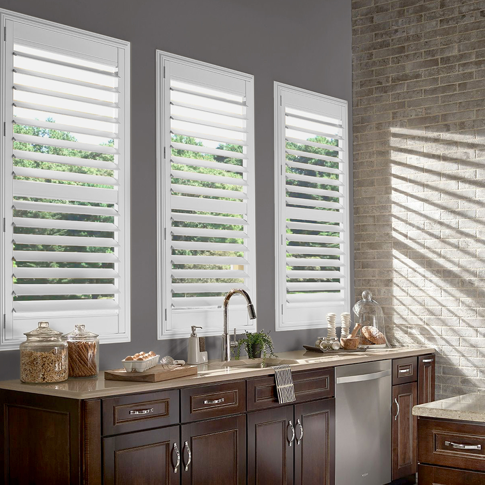 Plantation shutters with wide louvers in a bedroom
